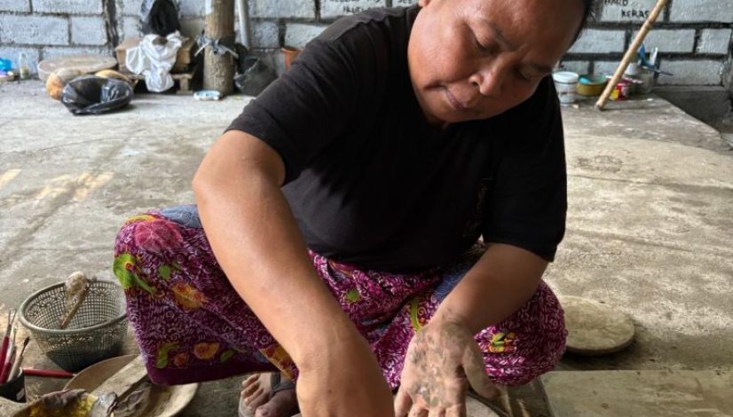 Traditional Lombok pottery artisan shaping clay by hand in Banyumulek village