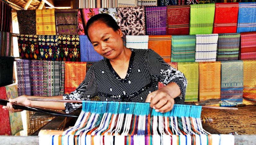 Traditional hand weaving process at Lombok Pottery Studio with local artisan crafting textile